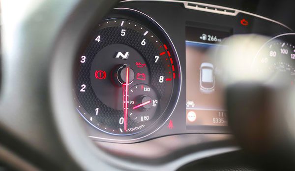 What should you do if the check engine light is flashing with the key on